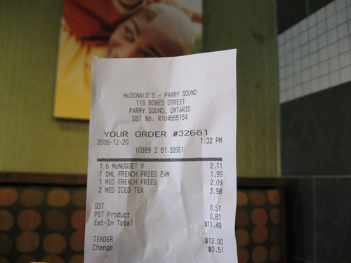 Our McDonald's bill showing our screwed up order.  Check out the pickle on the picture in the background (not our doing).