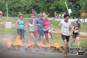 Nicola is ready to jump over the fire while I'm running beside it in the grass.