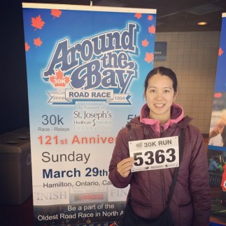 Mei at packet pick up with her race bib number