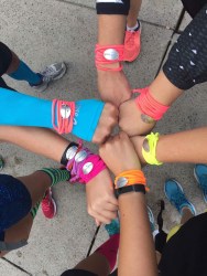 Everybody shows off their JP's Team bracelets.