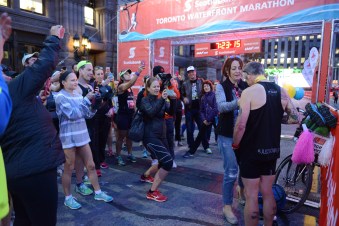 Mary-Anne puts JP's medals on him while JP's Team takes pictures.